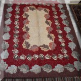 R38. Company C rug with a design of acorns and oak leaves.